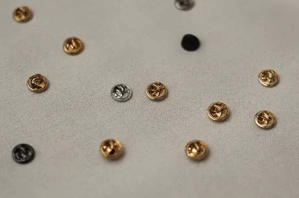 Different butterfly and rubber clutches for pins