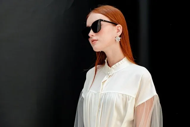 a person wearing sunglasses and a white top for how to measure sunglasses size