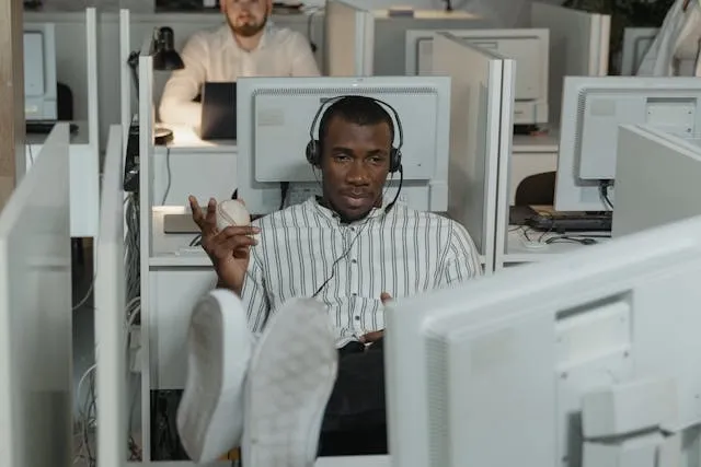a person holding a ball while working at a desk for what are stress balls made of